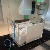 Figure 1: Custom phantom setup using RW3 slabs and rice bags in an acrylic container for tissue-equivalent simulation during extracorporeal irradiation.